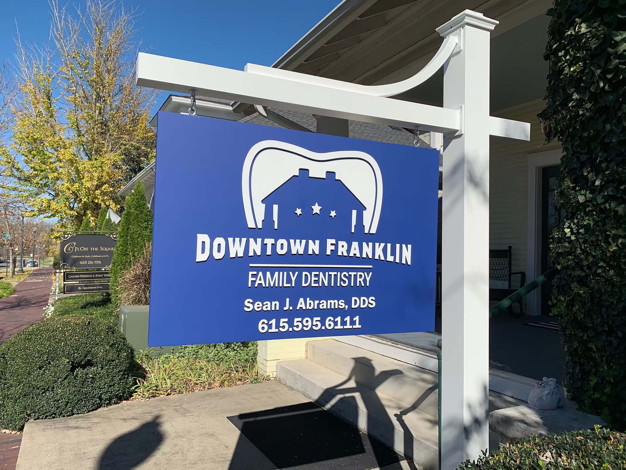 Post-and-panel business sign for a family dentistry practice